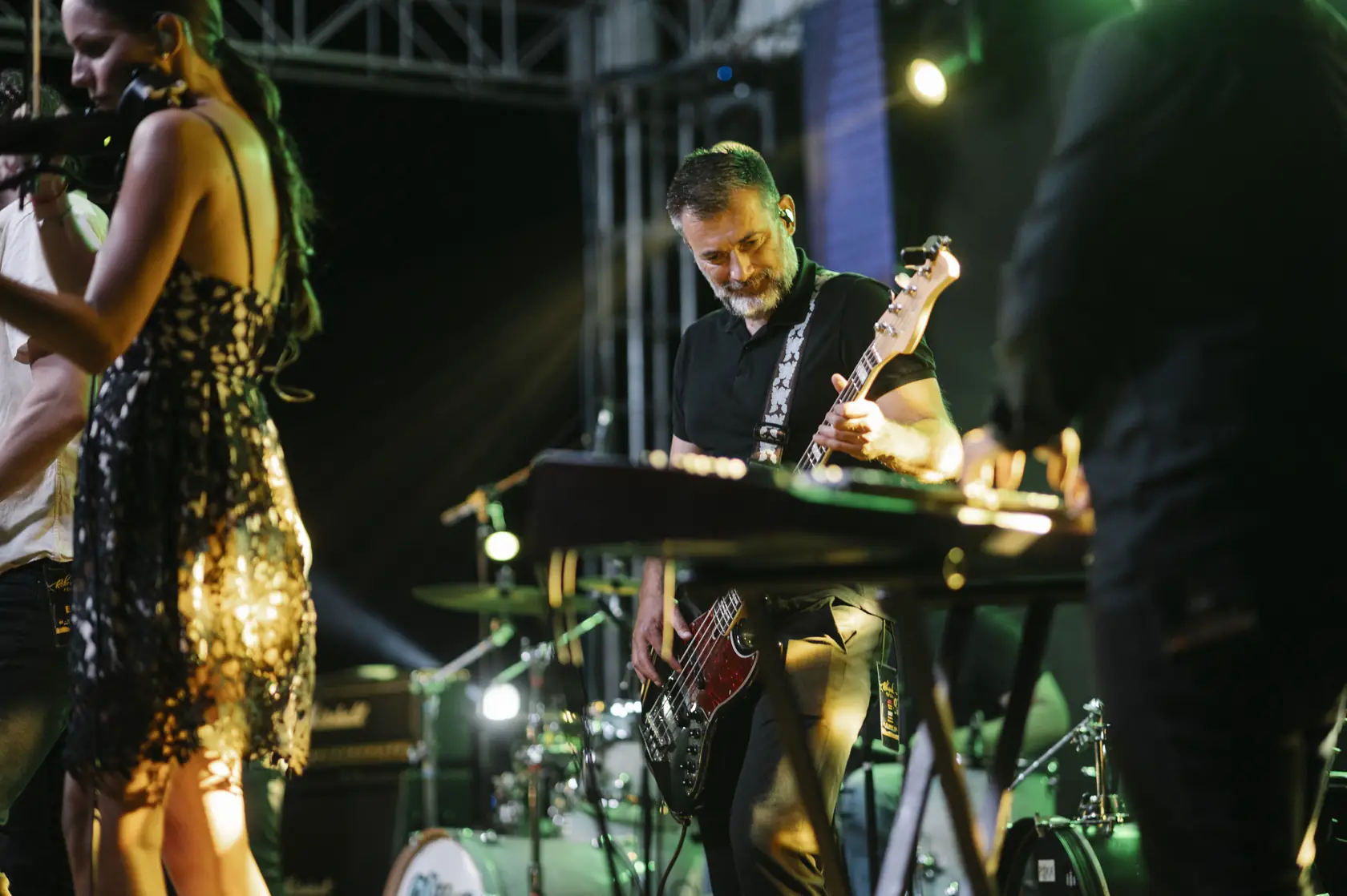 A performance on a brightly lit stage with vibrant coloured lighting